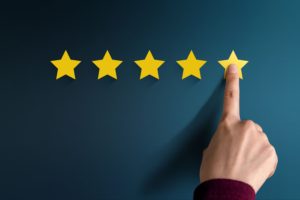 Image of finger pointing to 5-star review.