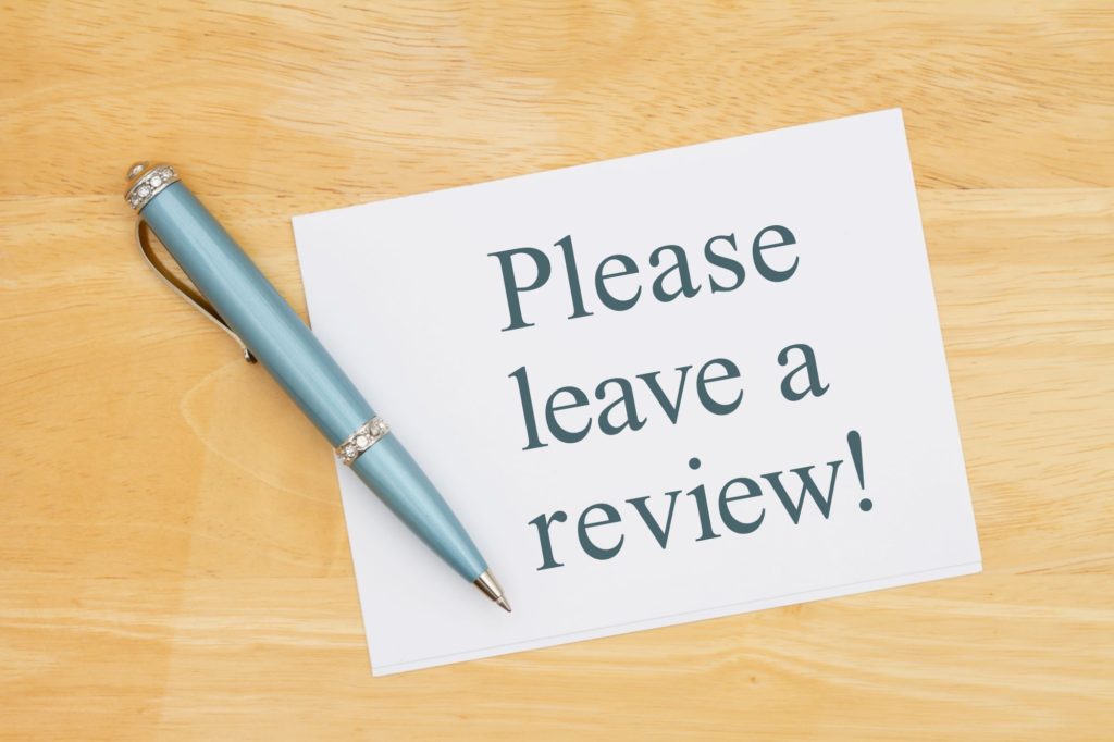 Image of paper and pencil saying "Please leave us a review".
