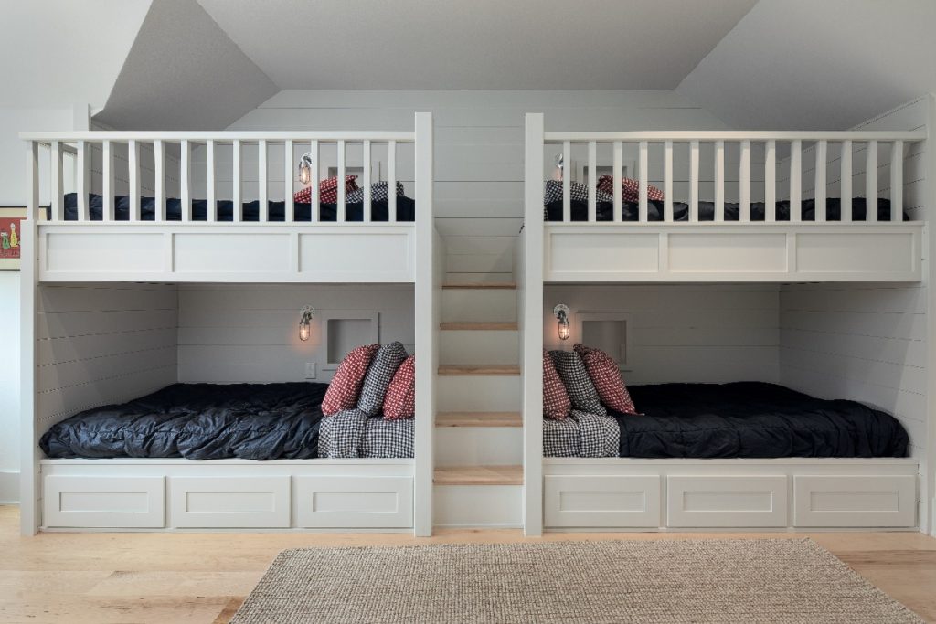 Bedroom in custom built home featuring built in custom bunk beds.