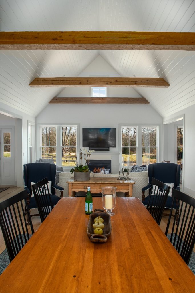Image of dining room table and large wood beams in custom home.