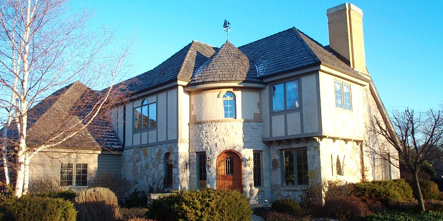 Tudor style Krajic custom home built by mikkelson Builders.  Stucco stone exterior with turret front.