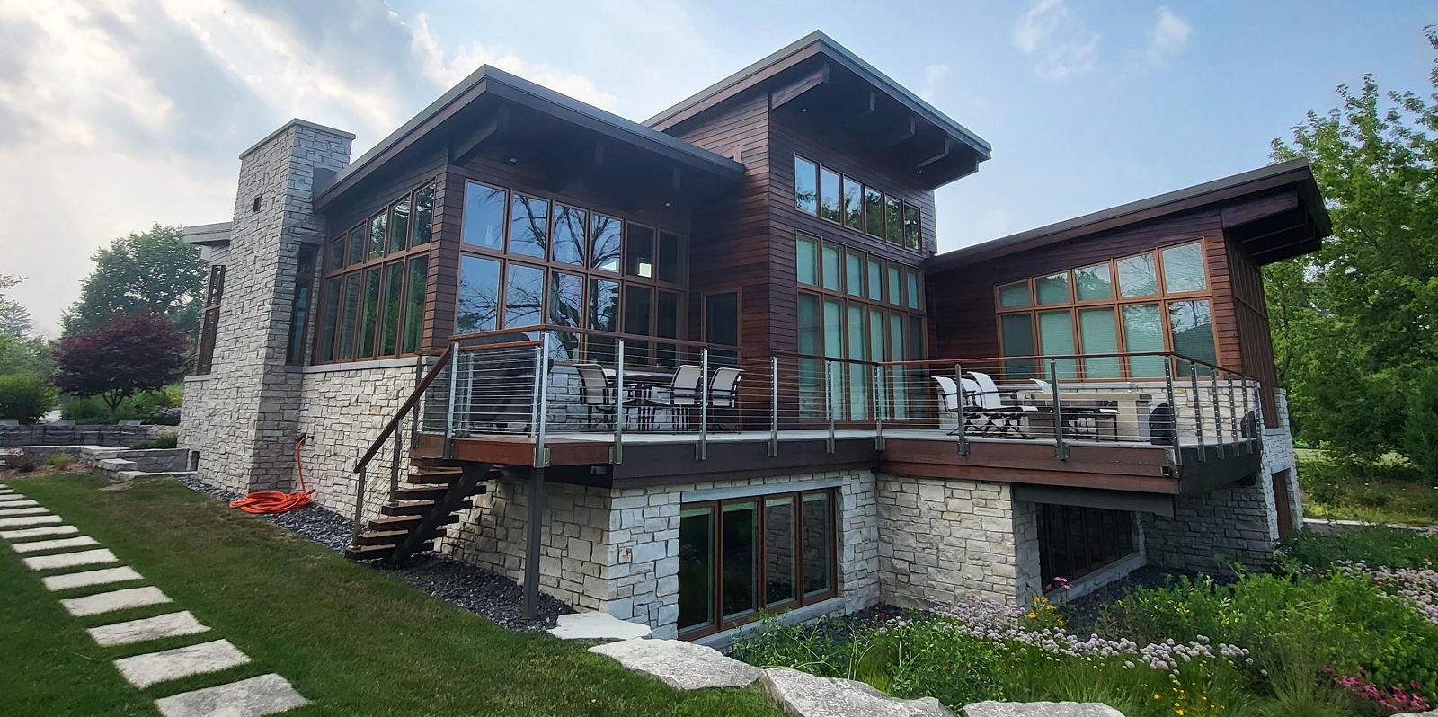 Exterior image of the butterfly house, a custom home built by Mikkelson Builders.  Modern prairie design featuring slanted roofs and multiple windows.