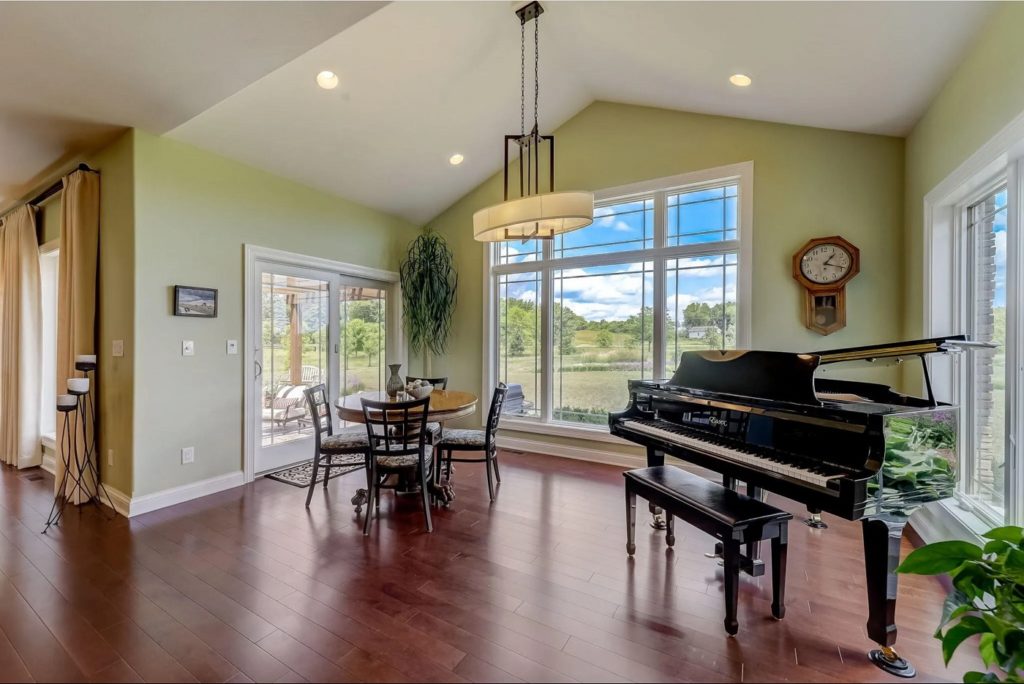Wilcox custom designed built home showing room with piano